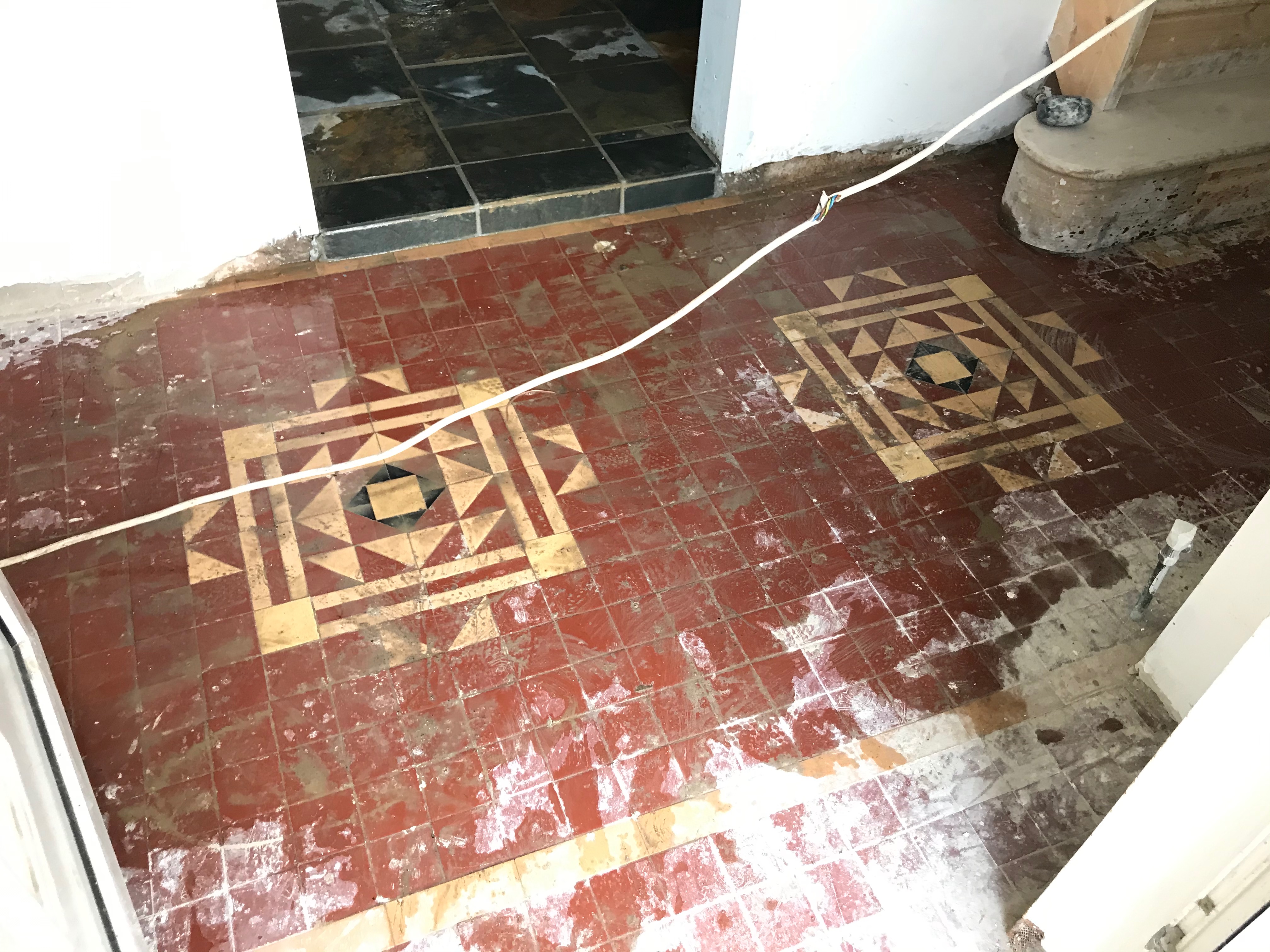 Geometric tile floor before restoration in Clogher, Tyrone